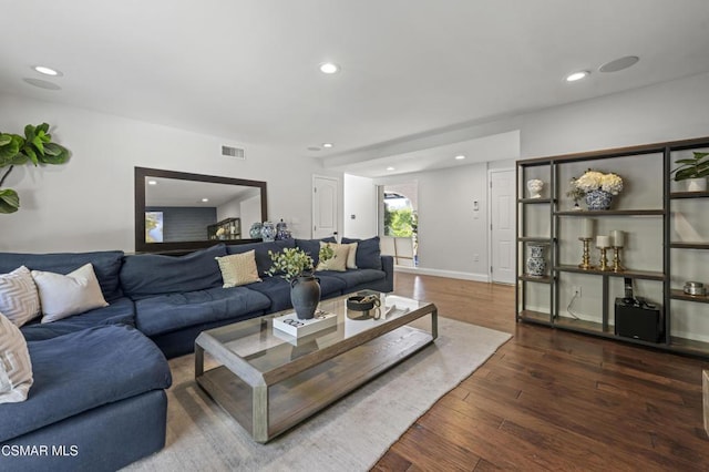 living room with dark hardwood / wood-style flooring