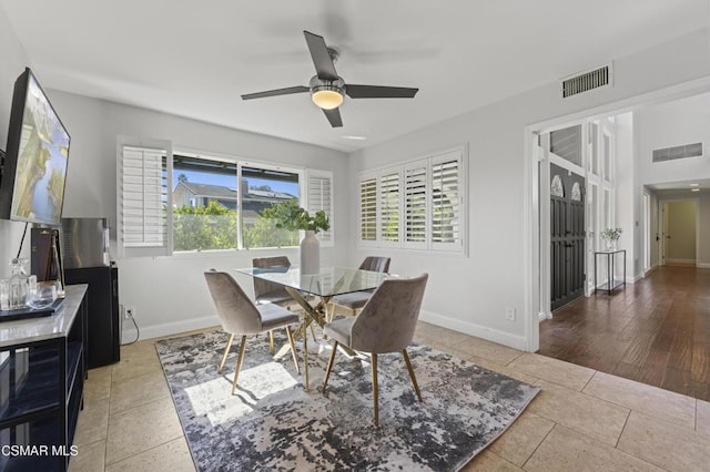 tiled dining area with ceiling fan and a healthy amount of sunlight