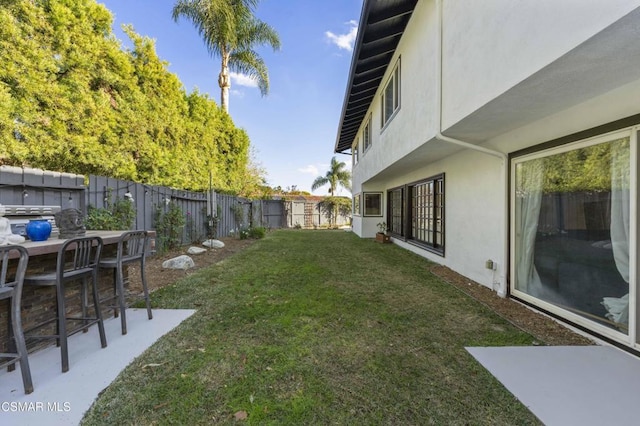 view of yard with a bar and a patio