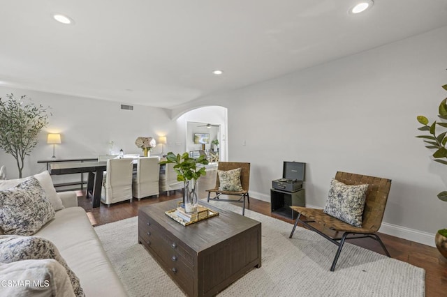 living room with ceiling fan and hardwood / wood-style floors