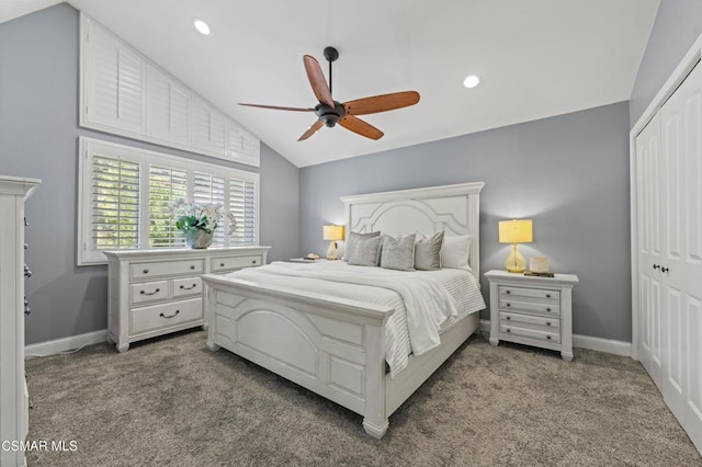 bedroom featuring a closet, carpet flooring, lofted ceiling, and ceiling fan