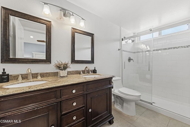 bathroom with toilet, tile patterned flooring, a shower with shower door, and vanity