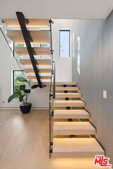 stairs featuring hardwood / wood-style flooring