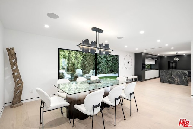 dining room featuring a chandelier and light hardwood / wood-style floors