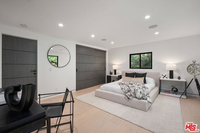 bedroom with light hardwood / wood-style floors