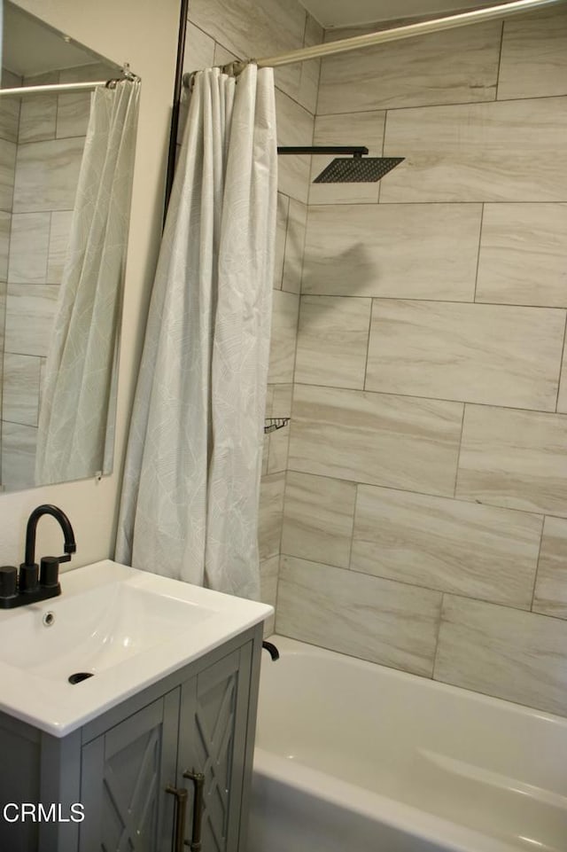 bathroom featuring vanity and shower / tub combo with curtain