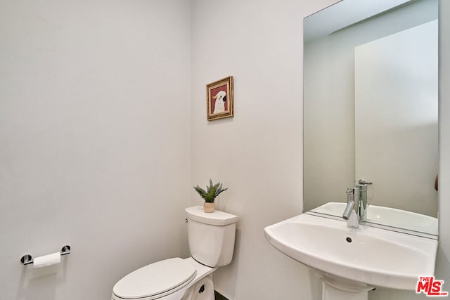 bathroom with toilet and sink