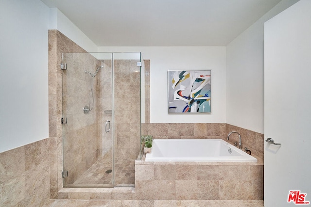 bathroom featuring separate shower and tub