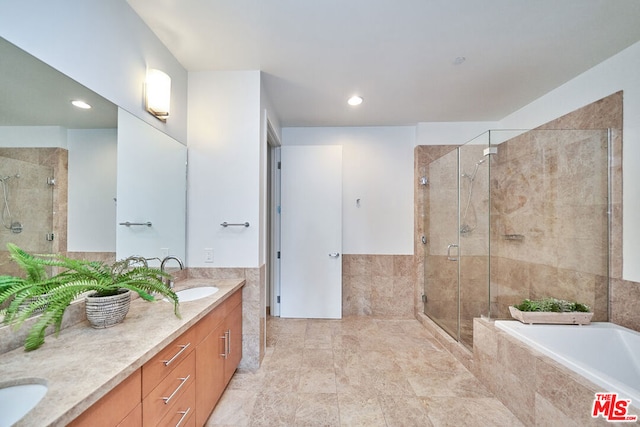 bathroom featuring vanity and separate shower and tub