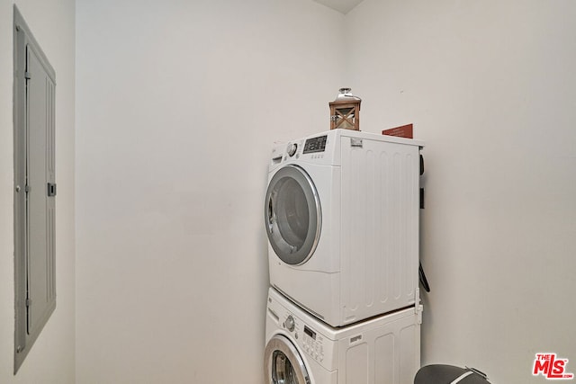 laundry area with stacked washing maching and dryer