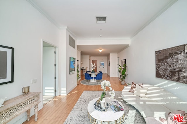 living room with light hardwood / wood-style floors and ornamental molding