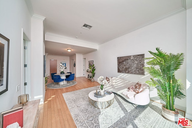 living room with hardwood / wood-style floors and crown molding