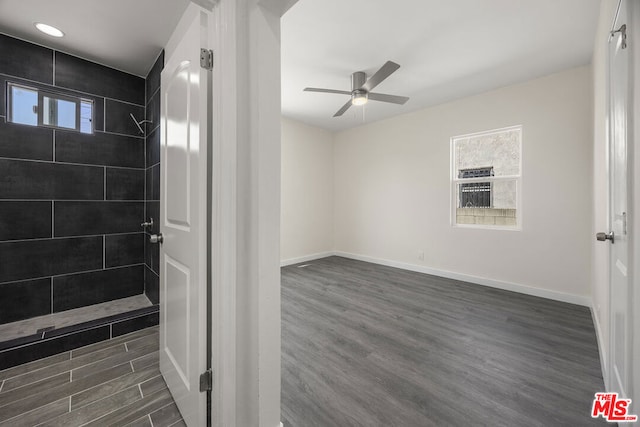 bathroom featuring ceiling fan, tiled shower, and hardwood / wood-style flooring