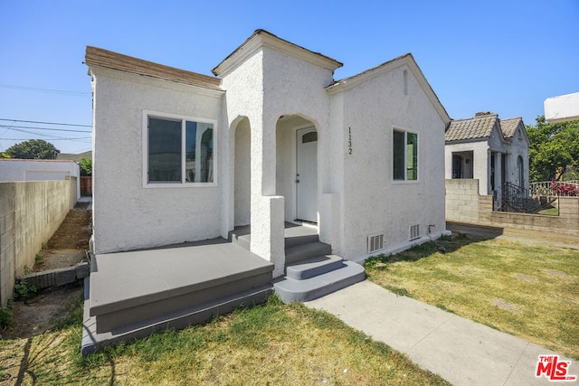 mediterranean / spanish-style home with a front yard