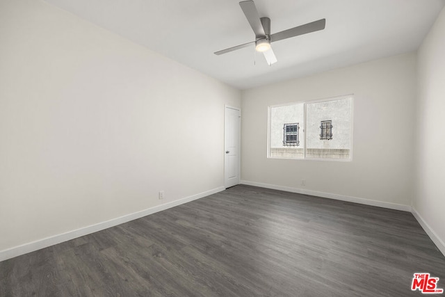 empty room with ceiling fan and dark hardwood / wood-style floors