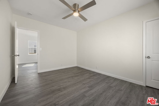 spare room featuring ceiling fan and dark wood-type flooring