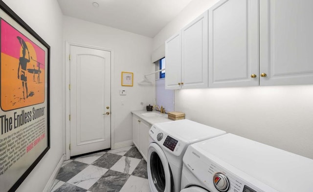 clothes washing area featuring washer and dryer, cabinets, and sink