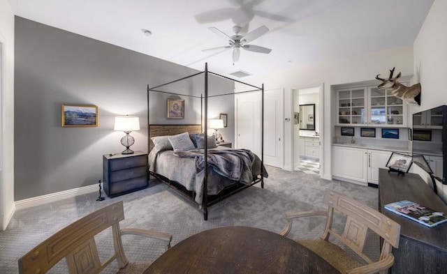 bedroom featuring ceiling fan, ensuite bathroom, and carpet floors