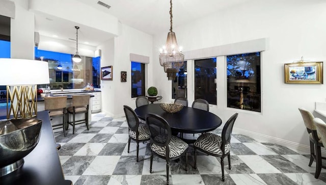 dining area featuring an inviting chandelier