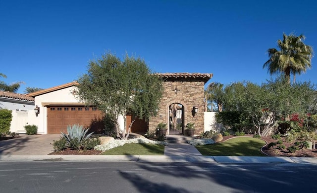 mediterranean / spanish home with a garage