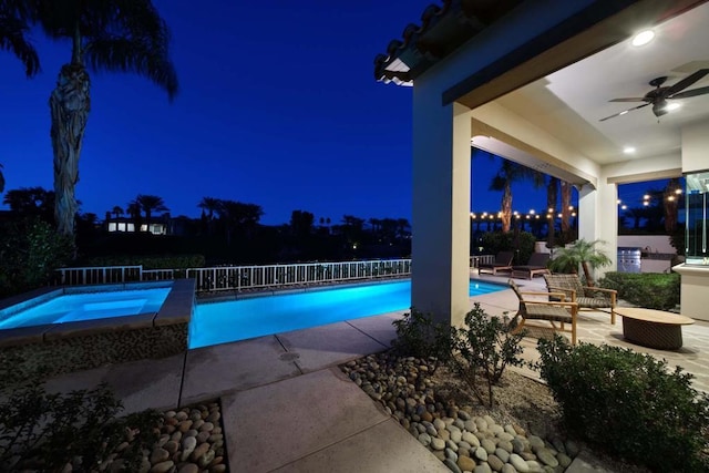 pool at twilight with ceiling fan, area for grilling, and a patio