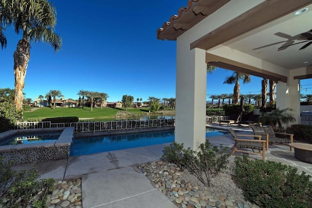 view of swimming pool with a patio area, an in ground hot tub, and ceiling fan