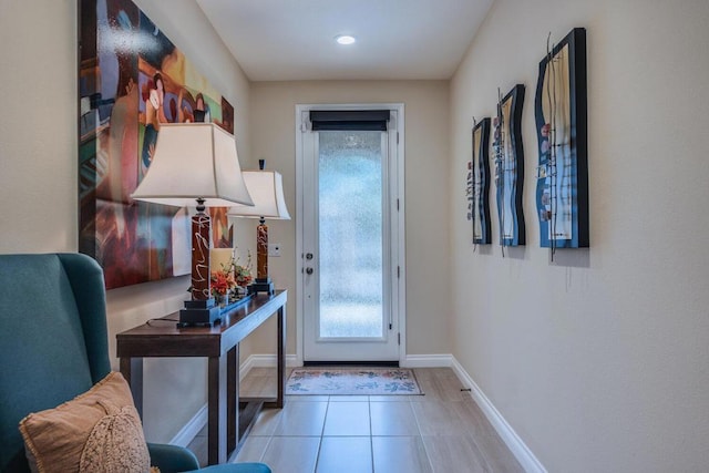 doorway to outside with light tile patterned floors