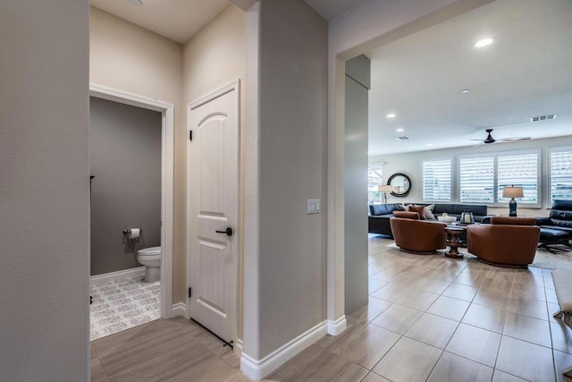 hallway featuring light tile patterned flooring