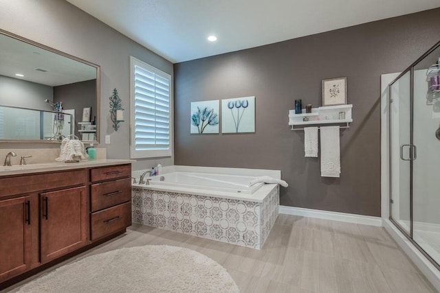 bathroom featuring separate shower and tub and vanity