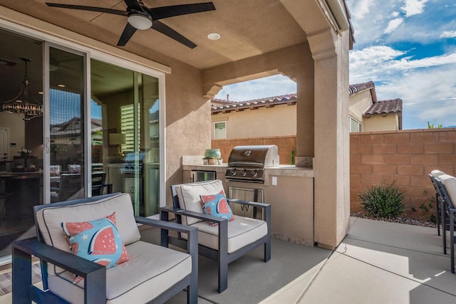 view of patio with ceiling fan, an outdoor kitchen, and grilling area