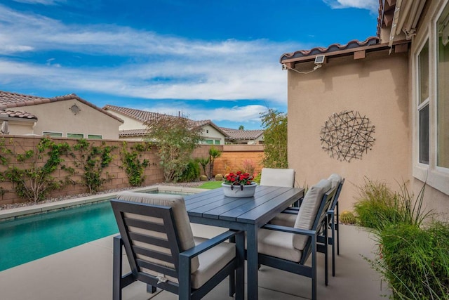 exterior space featuring a patio and an in ground hot tub