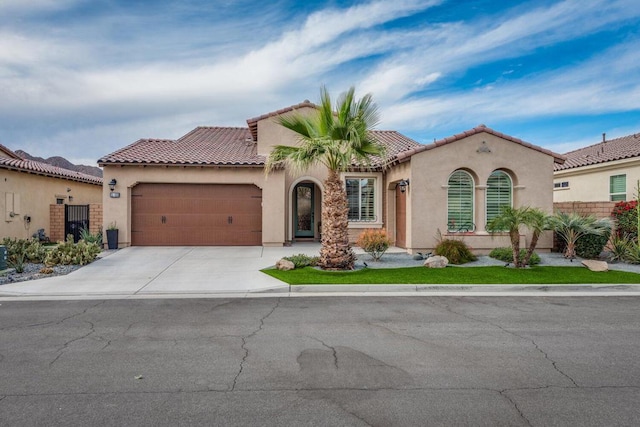 mediterranean / spanish-style home featuring a garage