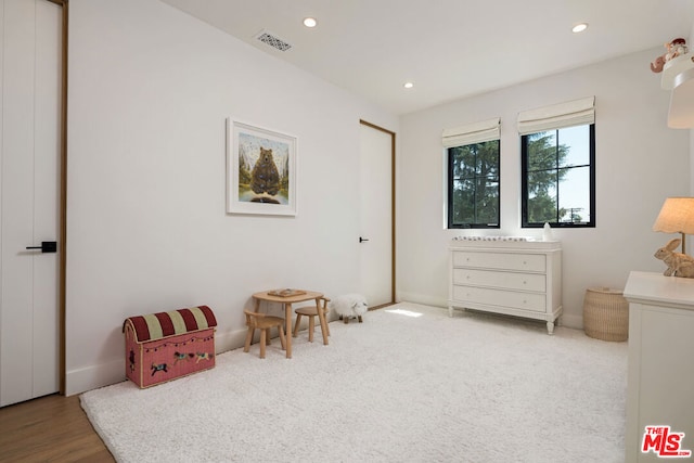 sitting room featuring light carpet