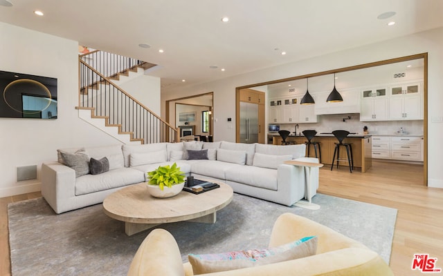 living room featuring light hardwood / wood-style floors and sink