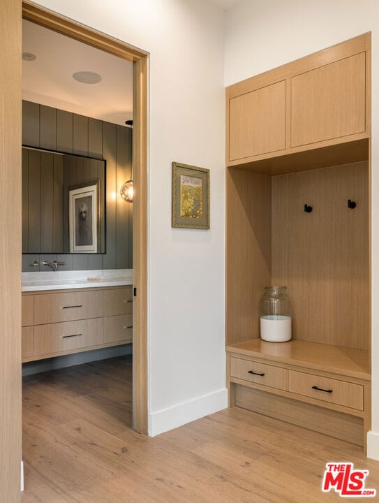 mudroom with light hardwood / wood-style flooring