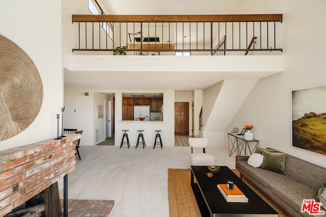 living room with carpet and a towering ceiling