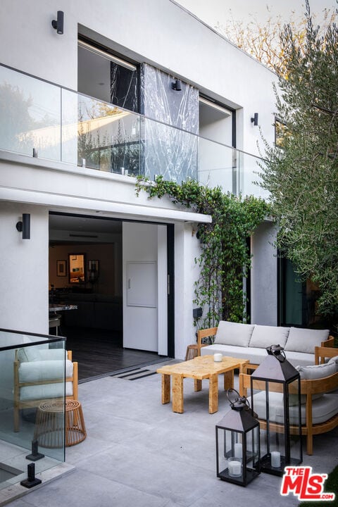 rear view of property featuring an outdoor living space