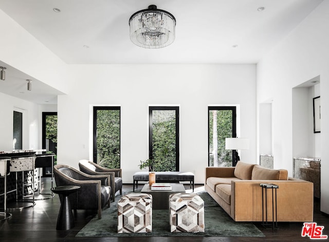 living room with a chandelier and dark hardwood / wood-style floors