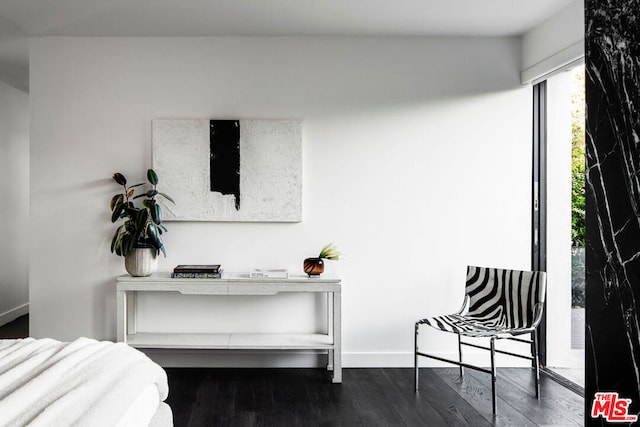 bedroom with dark hardwood / wood-style flooring