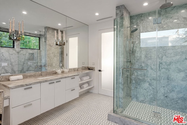 bathroom featuring an enclosed shower and vanity