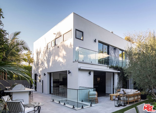 rear view of house featuring an outdoor bar, an outdoor hangout area, and a patio