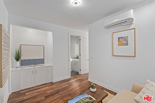 living room with a wall mounted AC and dark hardwood / wood-style floors