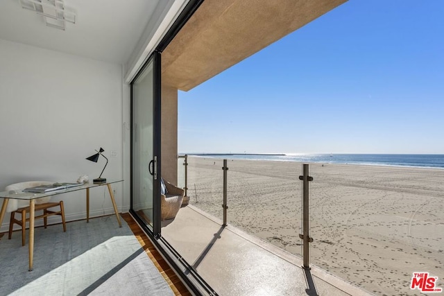 balcony featuring a water view and a beach view