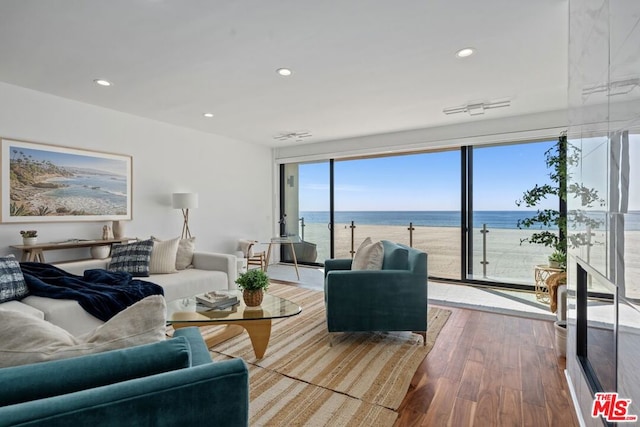 living room with a water view and hardwood / wood-style flooring