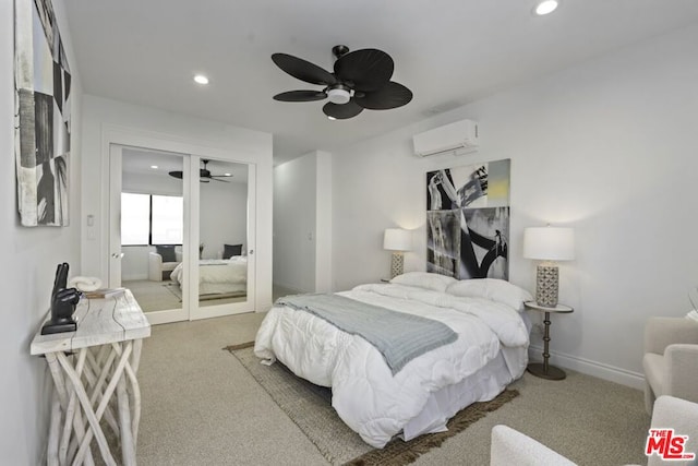 bedroom with ceiling fan, carpet floors, and a wall mounted air conditioner