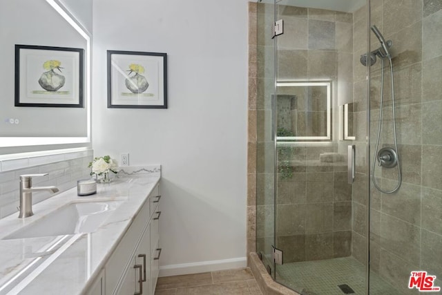 bathroom with an enclosed shower and vanity