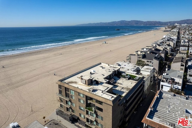 bird's eye view with a water view and a beach view