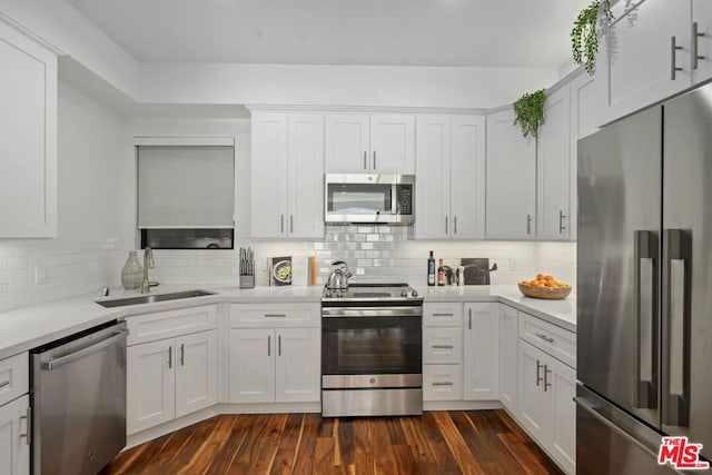 kitchen featuring white cabinets, appliances with stainless steel finishes, and sink