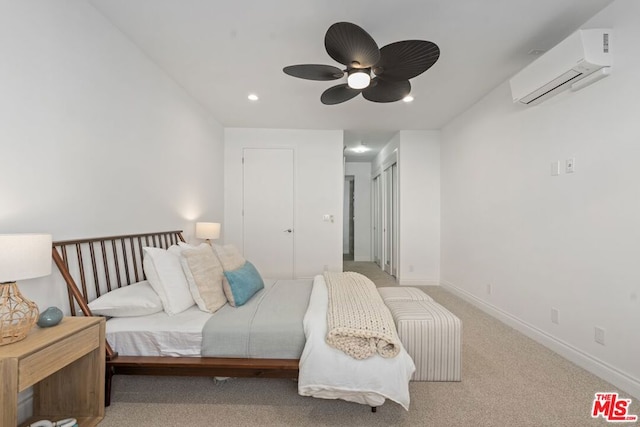 carpeted bedroom with ceiling fan, a wall mounted AC, and a closet