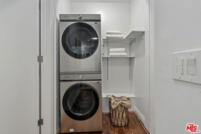 laundry room featuring stacked washing maching and dryer and dark wood-type flooring